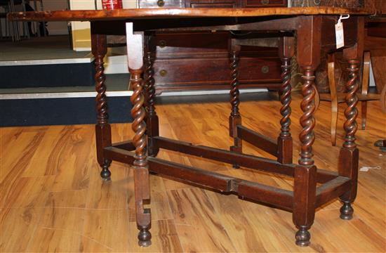 An 18th century walnut oval gateleg dining table, extended 4ft 9in.